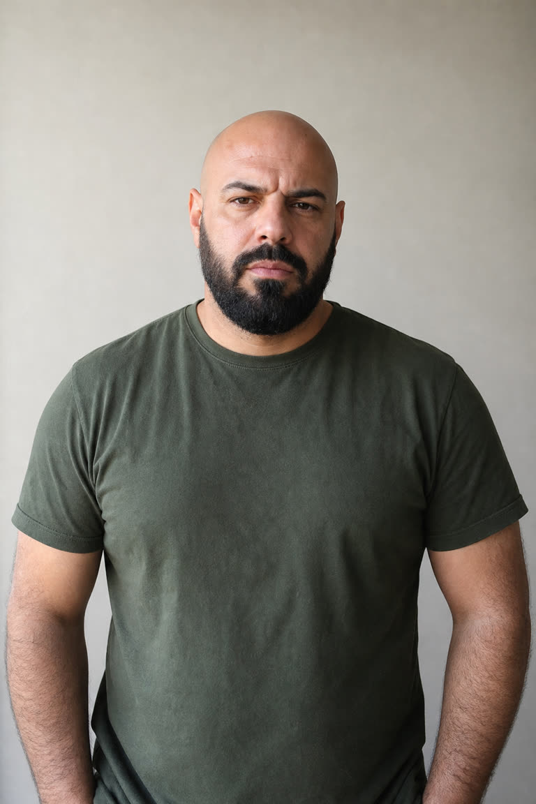 Input chaser for Crazy Frog AI example 7: a bald man with a black beard in an olive T-shirt (AI-generated sample person)